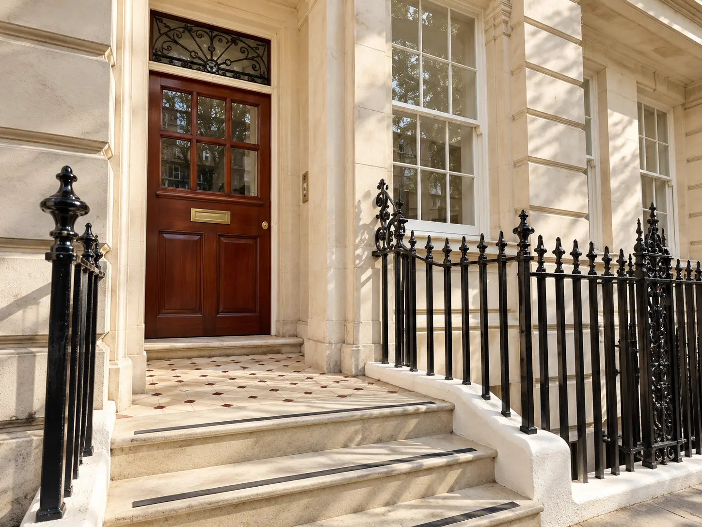 Daylight architectural study of a refined Marylebone townhouse entrance with limestone steps and black railings